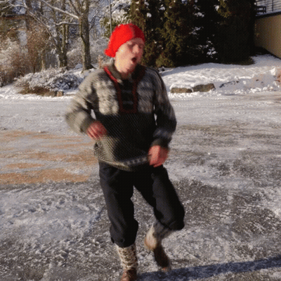A Man Wearing A Red Hat And A Sweater Is Running On The Ice GIF