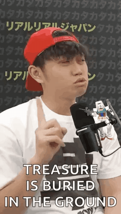 A Man Wearing A Red Hat And A White Shirt Is Talking Into A Microphone While Holding A Toy Robot . GIF