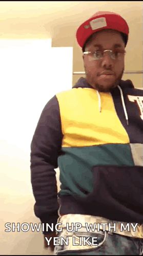 A Man Wearing A Red Hat And Glasses Is Showing Up With His Yen Like GIF