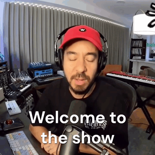 A Man Wearing A Red Hat And Headphones Says Welcome To The Show GIF