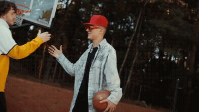 A Man Wearing A Red Hat And Sunglasses Is Holding A Spalding Basketball GIF