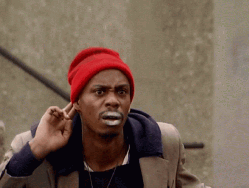 A Man Wearing A Red Hat Is Covering His Ears GIF