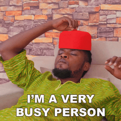 A Man Wearing A Red Hat Is Laying On A Couch With The Words I 'M A Very Busy Person Above Him GIF