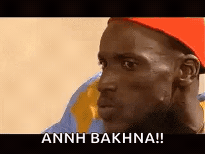A Man Wearing A Red Hat Is Making A Funny Face And Says Annh Bakhna ! GIF