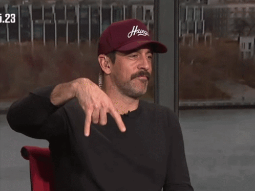 A Man Wearing A Red Hat That Says Hugs On It GIF