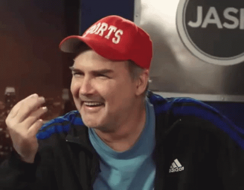 A Man Wearing A Red Hat That Says Sports Is Smiling GIF