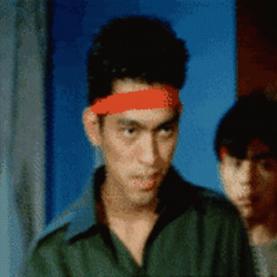 A Man Wearing A Red Headband Is Looking At The Camera GIF