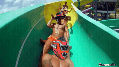 A Man Wearing A Red Helmet Is Sliding Down A Water Slide At General 'S GIF