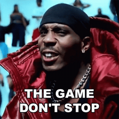 A Man Wearing A Red Jacket And A Black Headband Is Singing The Game Don 'T Stop . GIF