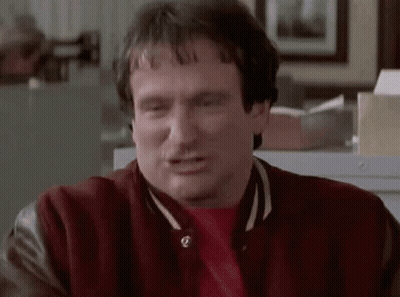 A Man Wearing A Red Jacket And A Red Shirt Is Making A Face . GIF