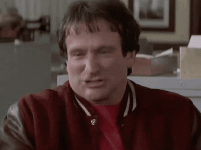 A Man Wearing A Red Jacket And A Red Shirt Is Making A Funny Face GIF