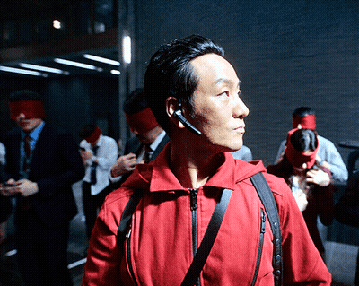 A Man Wearing A Red Jacket Has A Headset On GIF