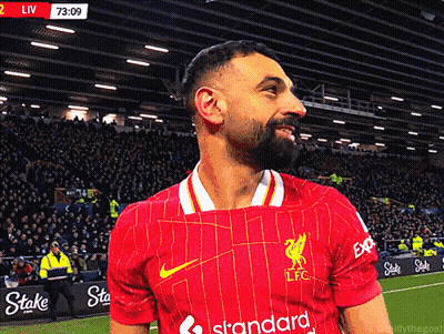 A Man Wearing A Red Jersey That Says Standard On The Front GIF