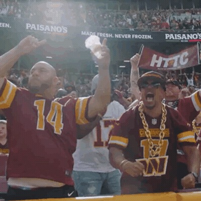 A Man Wearing A Red Jersey With The Number 14 On It Is Cheering GIF