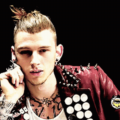 A Man Wearing A Red Leather Jacket With Spikes On It Talks On A Cell Phone GIF