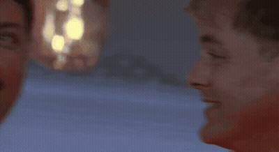 A Man Wearing A Red Life Jacket With A White Stripe On The Bottom GIF