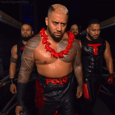 A Man Wearing A Red Necklace With A T On It GIF