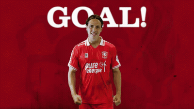 A Man Wearing A Red Pure Energie Shirt Stands In Front Of A Red Background GIF