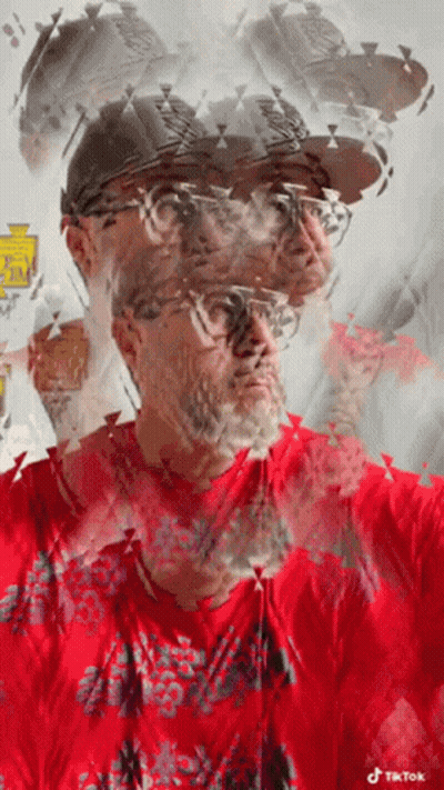 A Man Wearing A Red Shirt And A Hat Has A Tiktok Logo On His Shirt GIF