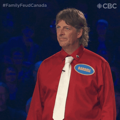 A Man Wearing A Red Shirt And Tie Has A Name Tag That Says Darrell GIF