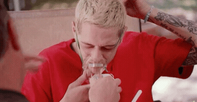 A Man Wearing A Red Shirt Is Using An Oxygen Mask GIF