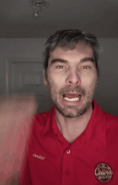 A Man Wearing A Red Shirt That Says Bitch On It GIF