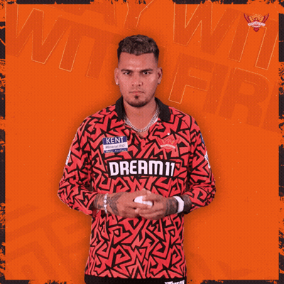 a man wearing a red shirt that says dream11 on it