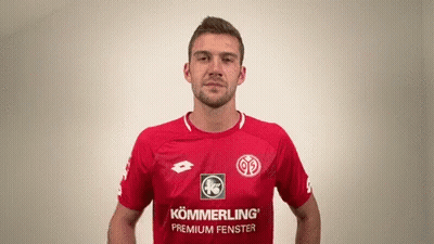 A Man Wearing A Red Shirt That Says Kommerling Premium Fenster On It GIF