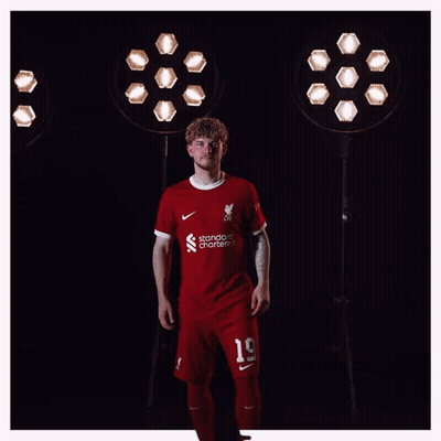 A Man Wearing A Red Shirt That Says Liverpool On It GIF