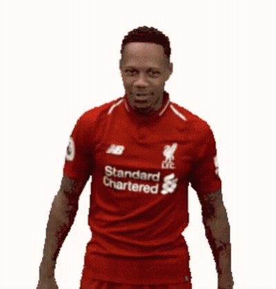 A Man Wearing A Red Shirt That Says Standard Chartered On It Is Laughing . GIF