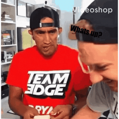 A Man Wearing A Red Shirt That Says Team Edge Looks At Something GIF