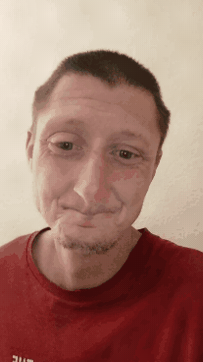 A Man Wearing A Red Shirt That Says Ufc On It Makes A Funny Face GIF