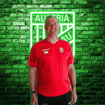 A Man Wearing A Red Shirt That Says Uhlsport GIF