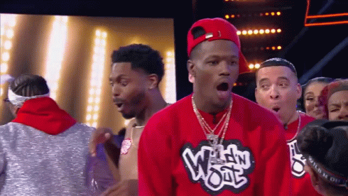 A Man Wearing A Red Shirt That Says Wild Wool GIF