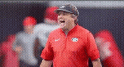 A Man Wearing A Red Shirt With The Letter G On It GIF