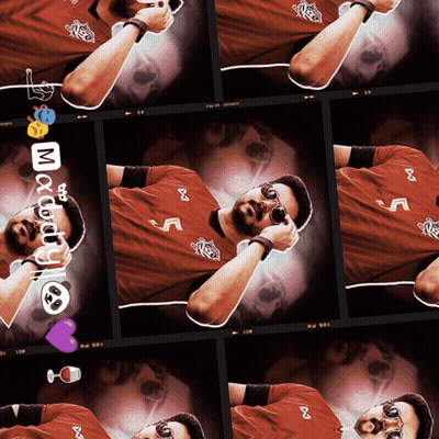 A Man Wearing A Red Shirt With The Letter M On It Is Laying Down GIF