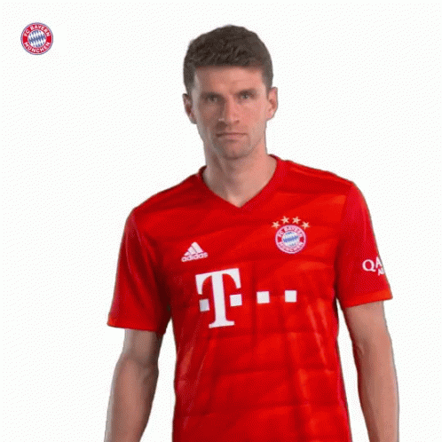 A Man Wearing A Red Shirt With The Letter T On The Front GIF