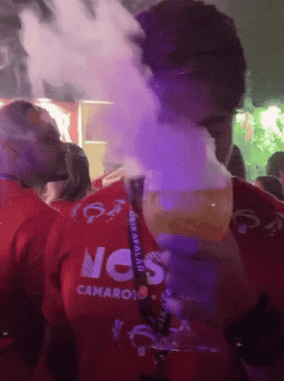 A Man Wearing A Red Shirt With The Word Camaro On It Is Smoking A Cigarette GIF