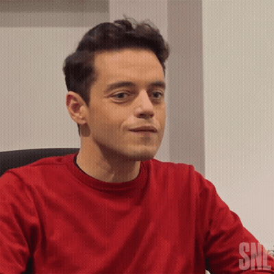 A Man Wearing A Red Shirt With The Word Snl On The Bottom GIF