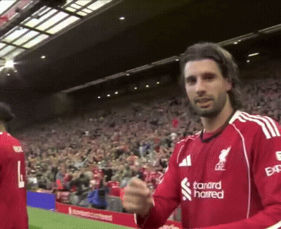 A Man Wearing A Red Shirt With The Word Standard On It GIF
