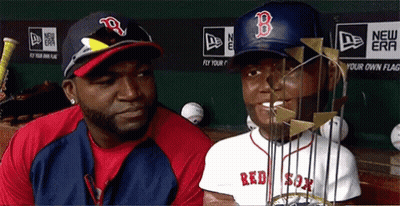 A Man Wearing A Red Sox Hat Stands Next To A Man Wearing A Red Sox Jersey GIF