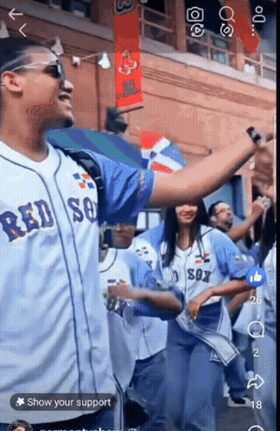 A Man Wearing A Red Sox Jersey Stands In Front Of A Crowd GIF