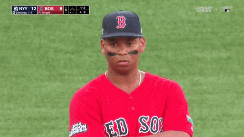 A Man Wearing A Red Sox Jersey Stands On A Baseball Field GIF