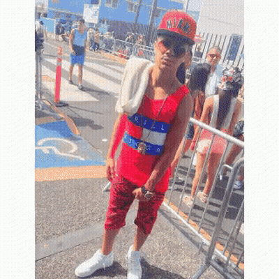 A Man Wearing A Red Tank Top And A Hat That Says M.i.a. On It GIF