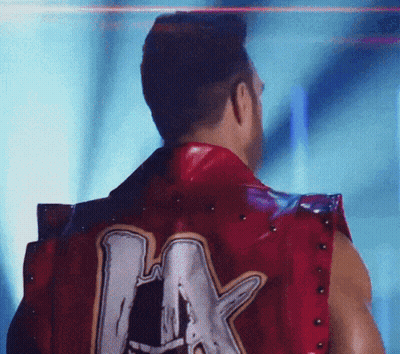 A Man Wearing A Red Vest With The Letter A On The Back GIF
