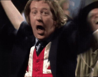 A Man Wearing A Red White And Blue Vest That Says L On It GIF