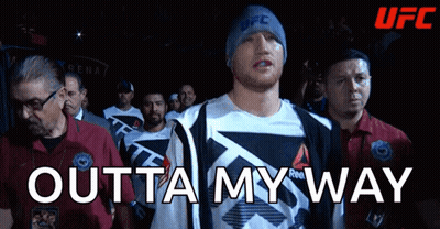 A Man Wearing A Reebok Shirt Walks Into A Ufc Ring GIF