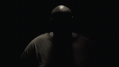 A Man Wearing A Reebok T-Shirt Is Looking At The Camera GIF