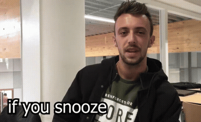 A Man Wearing A Reinforcedor T-Shirt Is Asking If You Snooze GIF