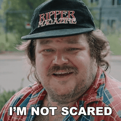 A Man Wearing A Ripper Magazine Hat Says He Is Not Scared GIF